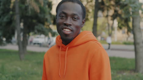 young man in orange hoodie