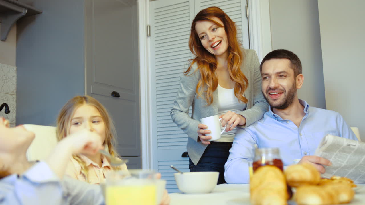Girl Caressing Her Brother While They Have Lunch In The Kitchen