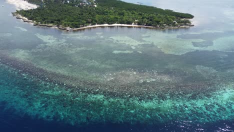 A-flight-towards-this-quiet-beach,-over-a-beautiful-coral-reef