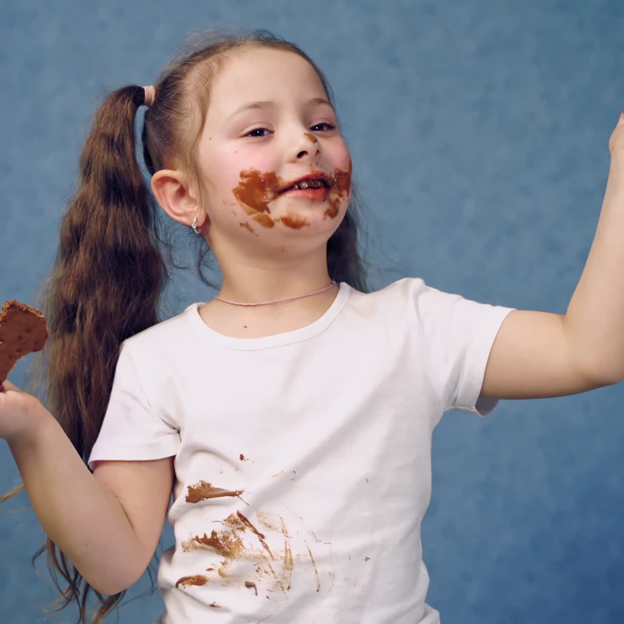 Happy girl eating chocolate