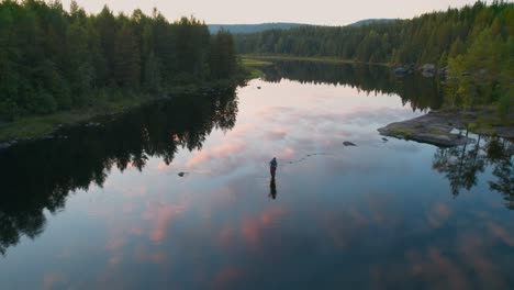 flying over a fly fisherman who is flyfishing in a river