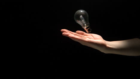 Mans-hand-throwing-bulb