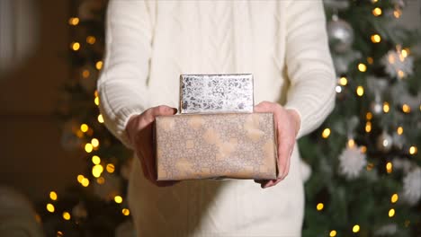 person holding christmas gifts