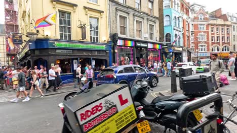 crowds and vehicles on a vibrant city street