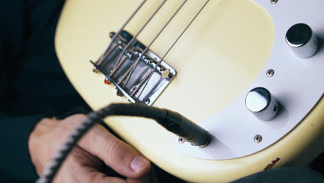 person rotates silver tone control knob and takes jack out