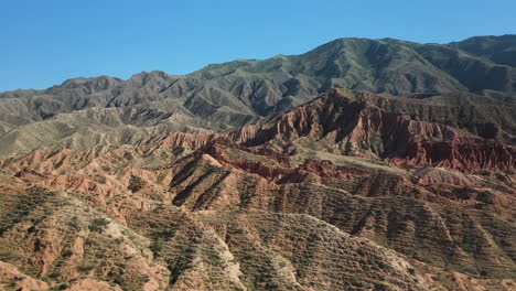 Shot-flying-over-mountain-ridges-at-Fairy-Tale-Canyon-near-Issyk-Kul-Lake-in-Karakol,-Kyrgyzstan,-Cinematic-drone-aerial-footage