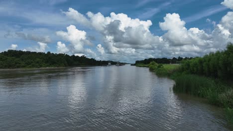 Busy-industrial-canal-with-2-barge-and-push-boats-in-Louisiana