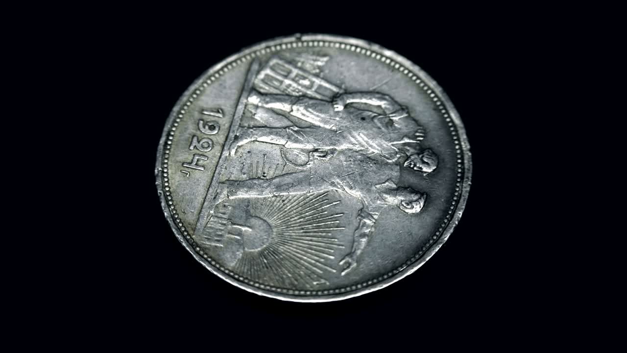 Soviet old rare coin 1 ruble 1924 of release rotates on a black background. Macro. Closeup