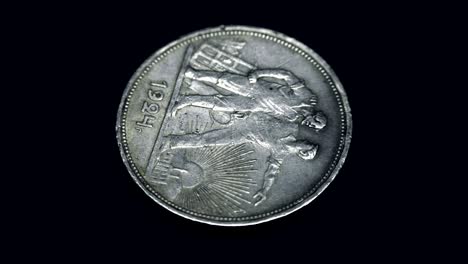 soviet old rare coin 1 ruble 1924 of release rotates on a black background. macro. closeup