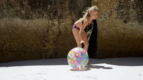 girl playing with ball in the beach 4k