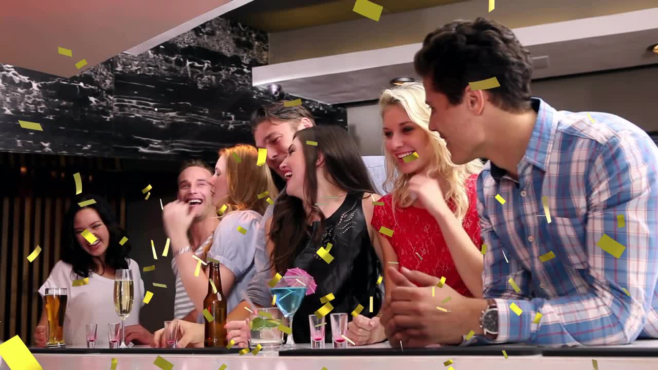 Seven friends raising red shots at nightlife bar, clinking, sipping, celebrating with confetti