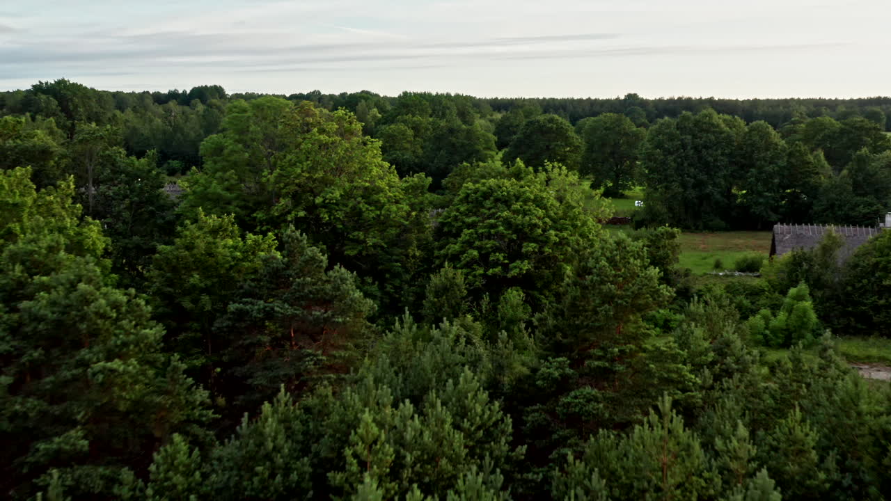 Flying in the countryside above houses, trees and roads
