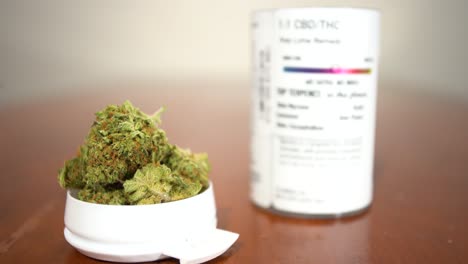 cannabis buds with cbd/thc product container