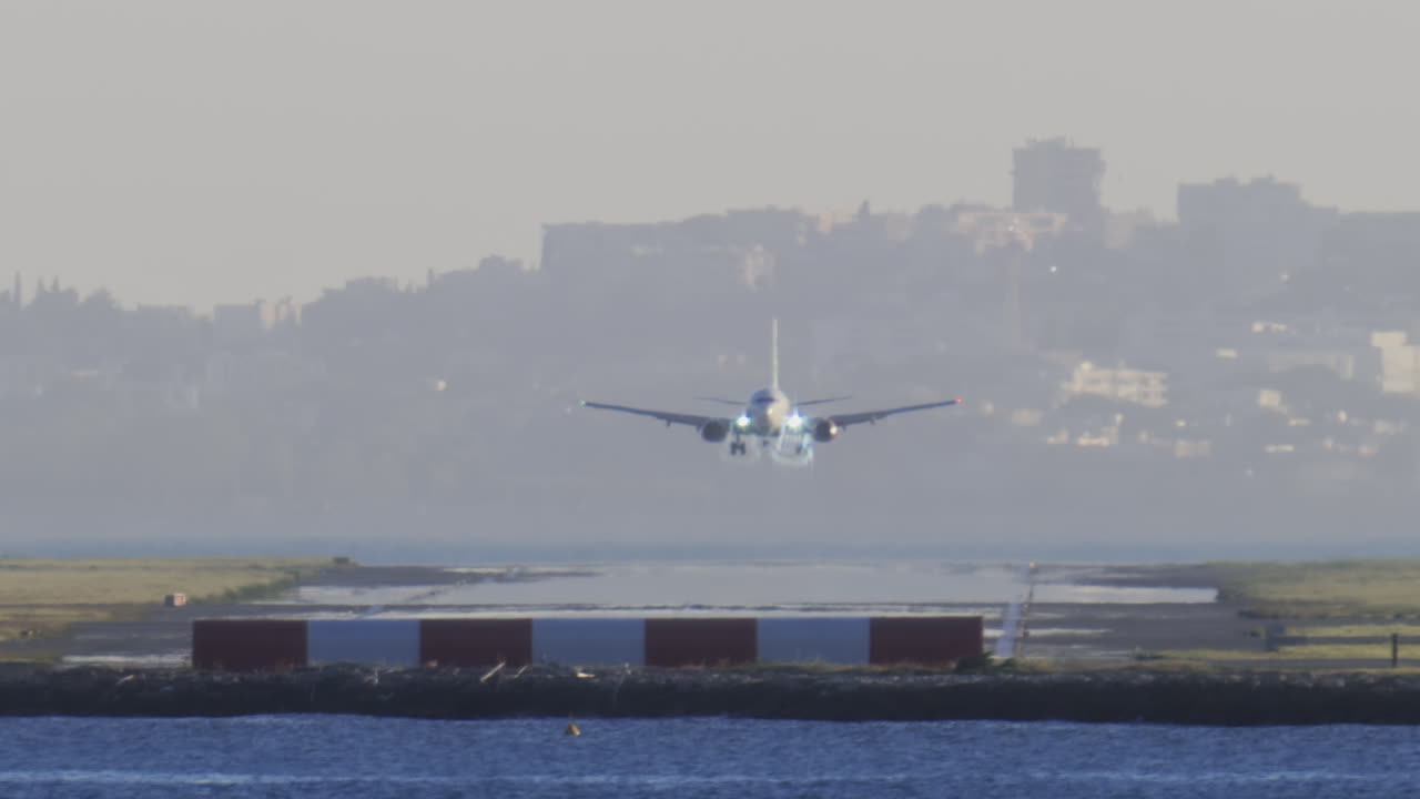 Distant view of airplanes landing at the Nice Cote d'Azur Airport in daylight