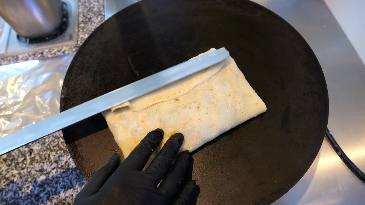 The chef spreads pancakes with filling