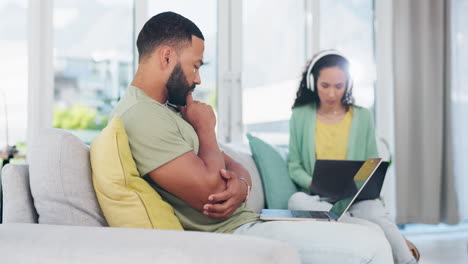 Man,-thinking-and-working-from-home-on-sofa