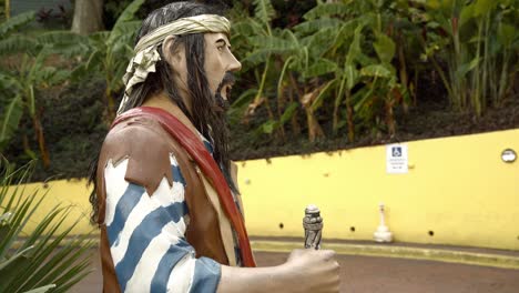 circling shot of pirate holding bottle at world famous mountain top #1 destination banana daquiri in st