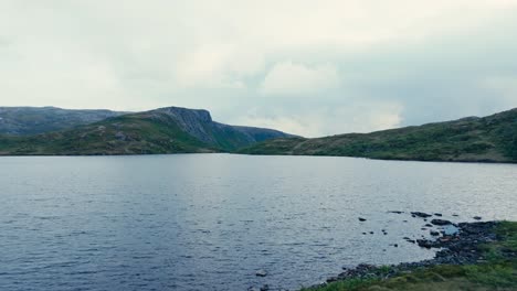 a wonderful setting of pålvatnet lake's placid waters in åfjord, trøndelag county, norway - drone flying forward