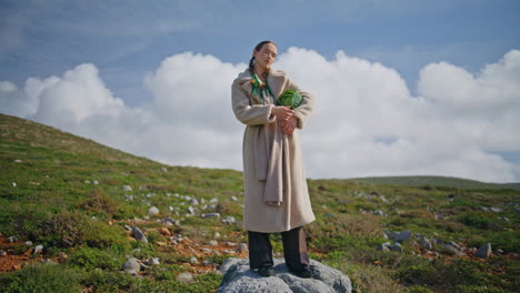 eco girl hold vegetables on sunny green hill. woman farmer posing with cabbage