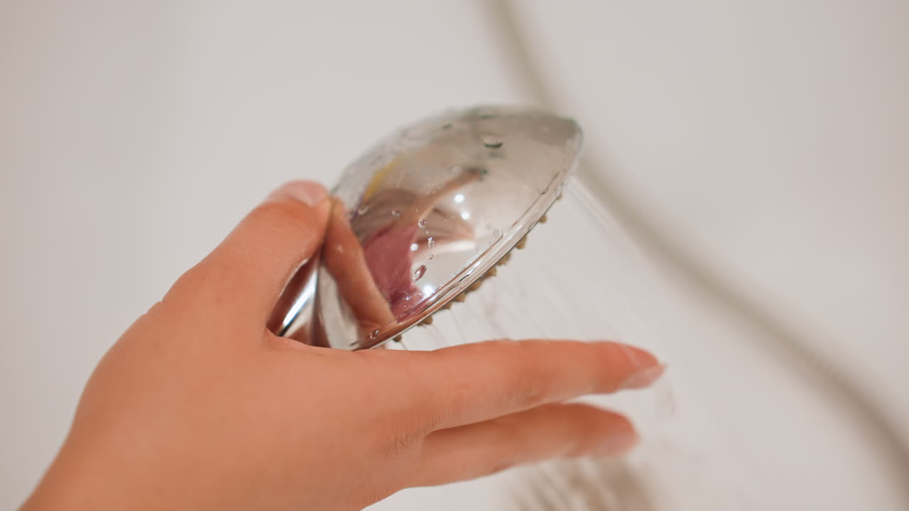 Chrome Handheld Shower Directing Water, Domestic Bathroom Faucet With Adjustable Spray In Chrome Finish, Practical Handheld Shower Device With Gentle Flow Adjustment In Local Bathroom Setting