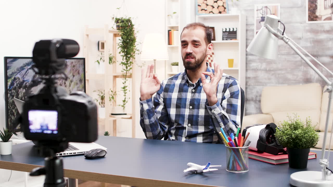 Man filming vlog at his home studio