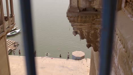 shot of ganges riverbank through a railing