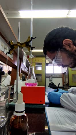 scientist reviewing lab notes during experiment