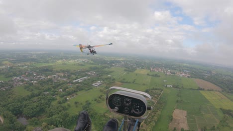 POV-from-cockpit-of-ultralight-aircraft-flying-along-in-front