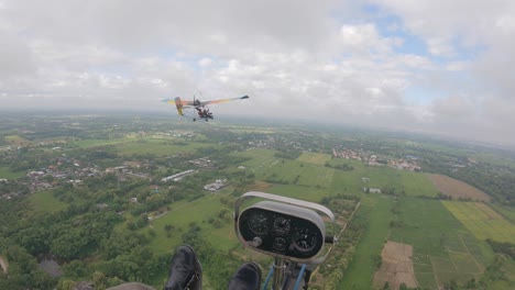 pov from cockpit of ultralight aircraft flying along in front