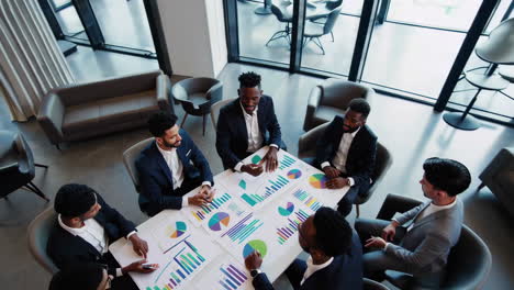 business professionals analyzing data and charts in a meeting