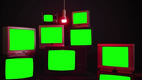 stack of retro vintage tv turning on green screens.