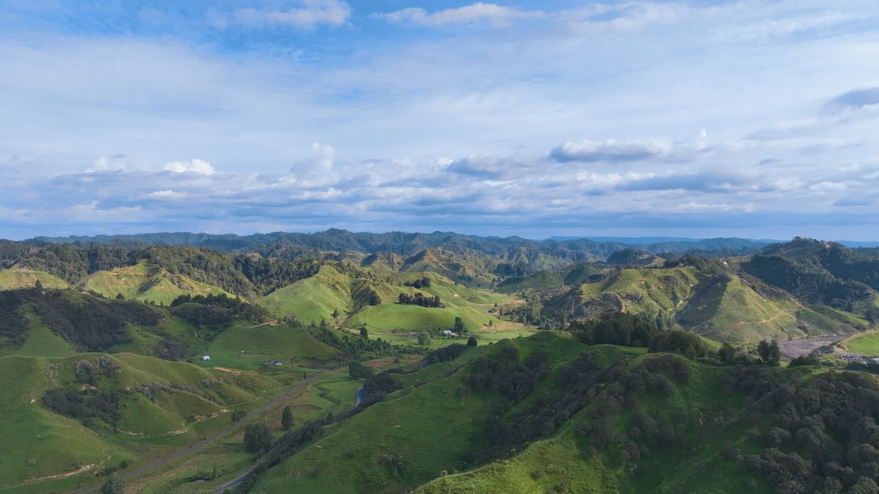 Flight high above the valleys, hills, and peaks of inland Taranaki, Aotearoa New Zealand. Rich farming pastures, and areas of native bush surround rivers amongst an active geological landscape