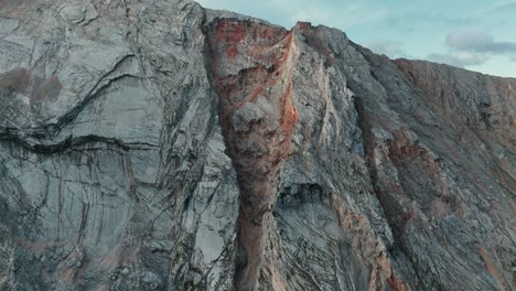 Stunning-mountain-wall-close-up-in-Pederü,-South-Tyrol,-showcasing-unique-rock-formations-under-a-blue-sky