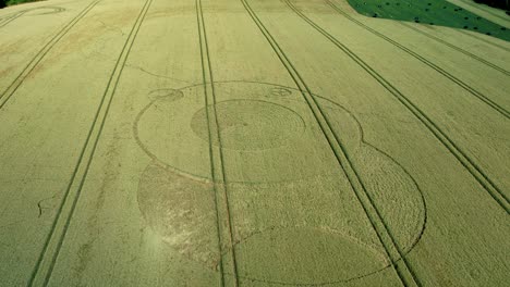 wiltshire wootton rivers mysterious crop circle in countryside farmland field aerial view pull back reveal