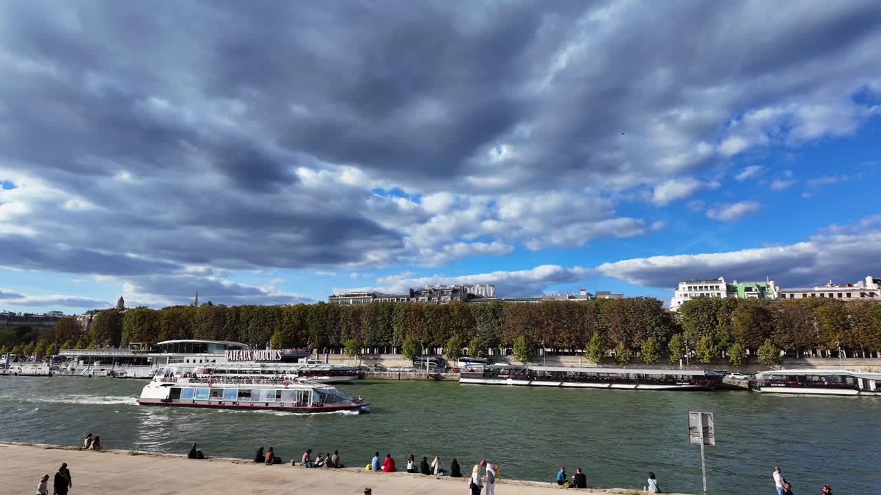 Seine river boat Paris capital of France with people walking summer day