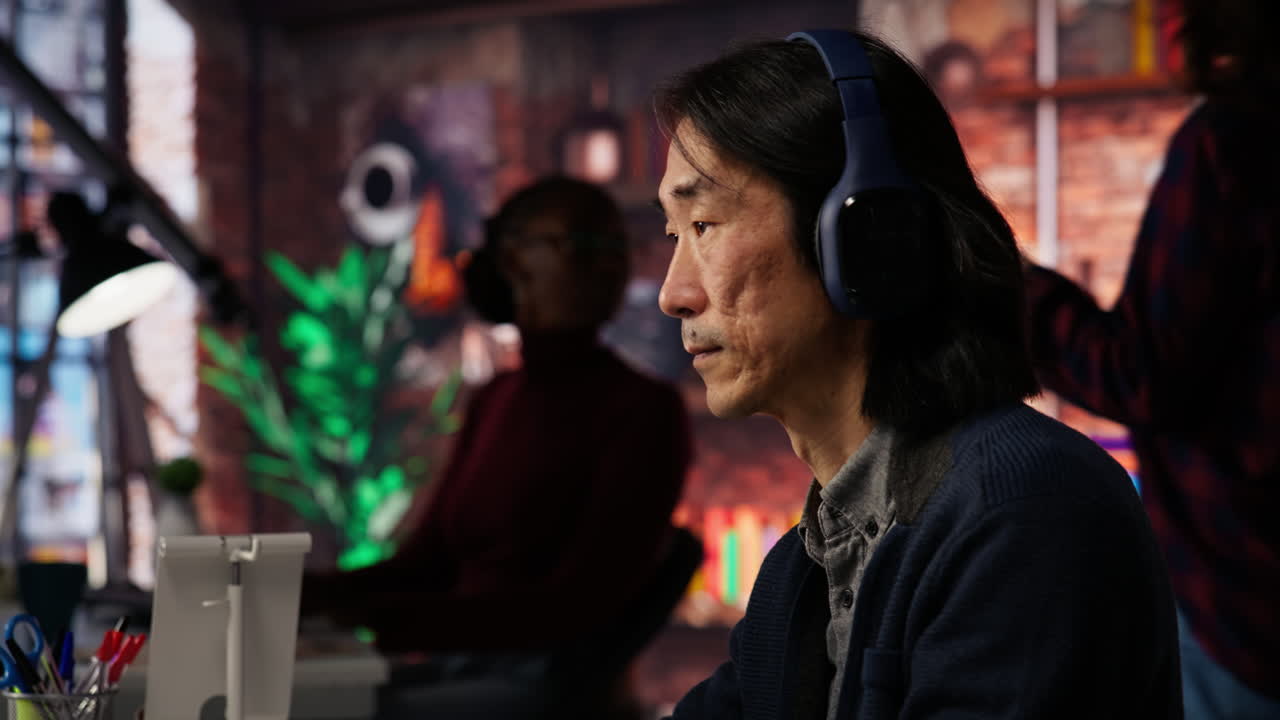 Startup office chief technology officer listens music while coding application