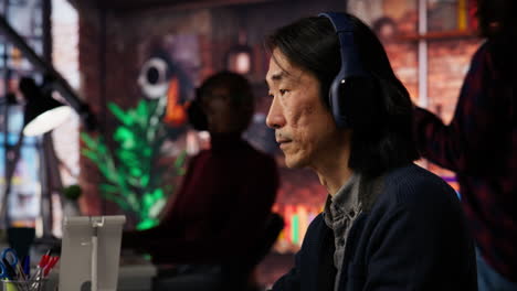 startup office chief technology officer listens music while coding application