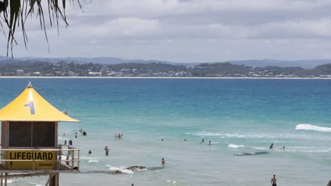 people enjoying the beach under lifeguard supervision