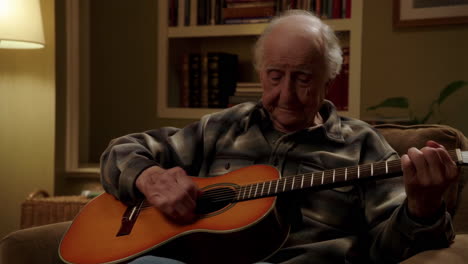 elderly man playing guitar