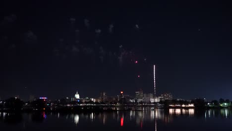 harrisburg, pennsylvania - july 4, 2022: fireworks over the capital city of harrisburg, pennsylvania from across the susquehanna river in high speed