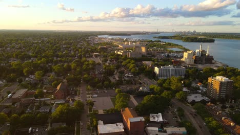 downtown wyandotte with residential and industrial areas by detroit river on sunlight evening