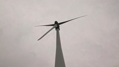 wind turbine blades rotating in a rural area