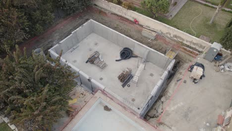 aerial orbital dolly plan of a house under construction in the city of malaga, spain