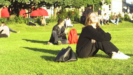 people relaxing in a city park