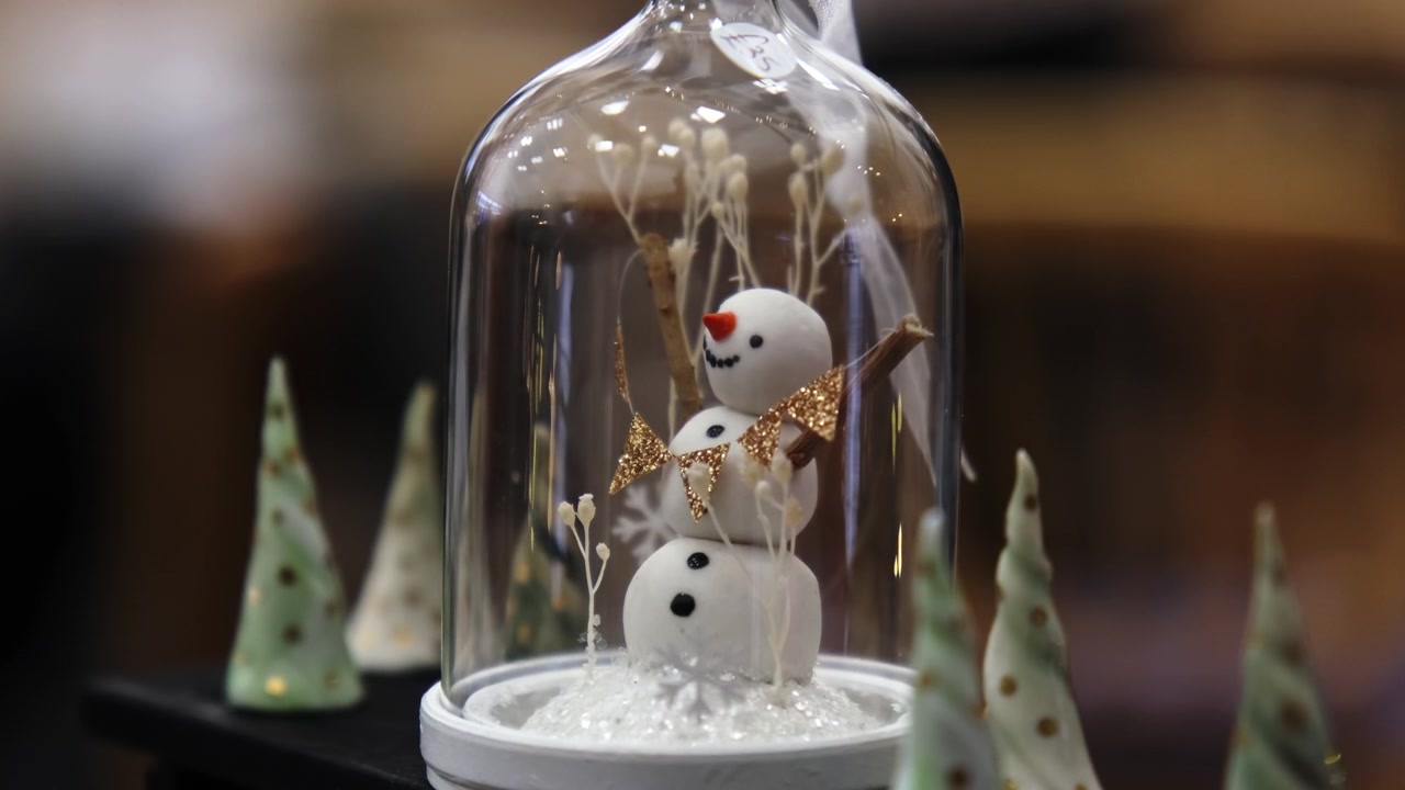 Close up shot of handmade snowman in Christmas snow globe.