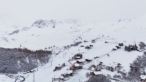 Bright-and-foggy-aerial-over-Arosa-skiing-resort-slope-and-cable-car-system