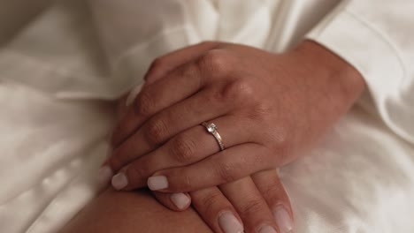Close up of hands with wedding rings, showing intimacy and love
