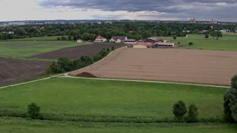 Ingolstadt-in-Bavaria,-shot-from-the-west-end-towards-downtown-with-Münster-cathedral-and-farm-Antoniusschwaige-in-the-front