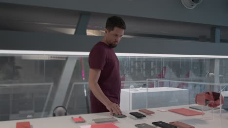 man examining phone cases in a tech store