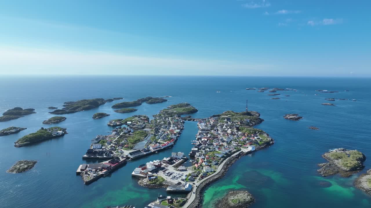 Wide aerial overview of Henningsvaer archipelago in Lofoten showing islands on a bright summer day